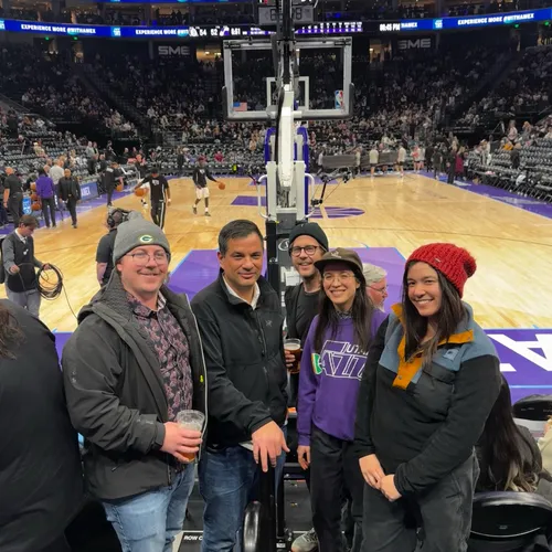 Amy and her siblings courtside at a Utah Jazz basketball game